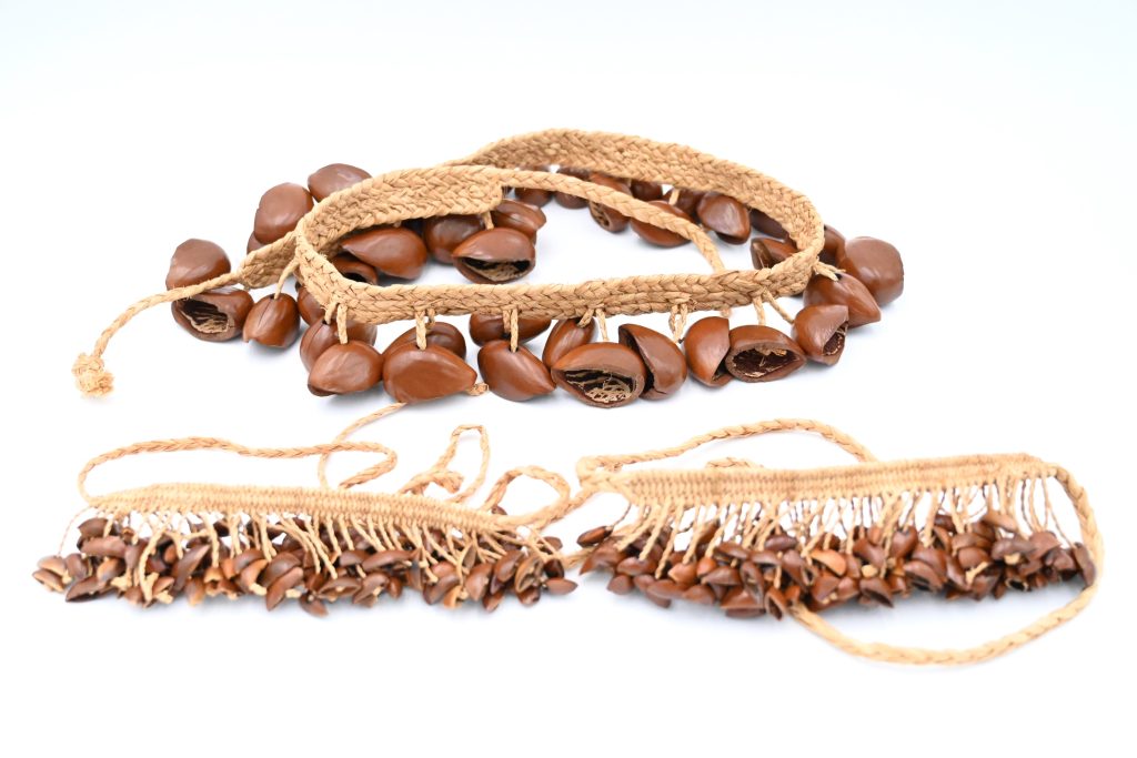 Seed shells on a woven strap