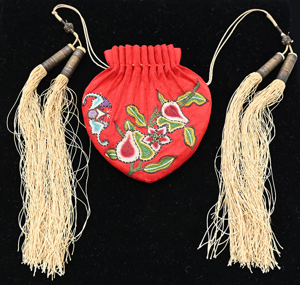 Small red pouch with 4 off-white tassels